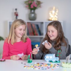 Shows both girls playing with Plus Plus Pastels together