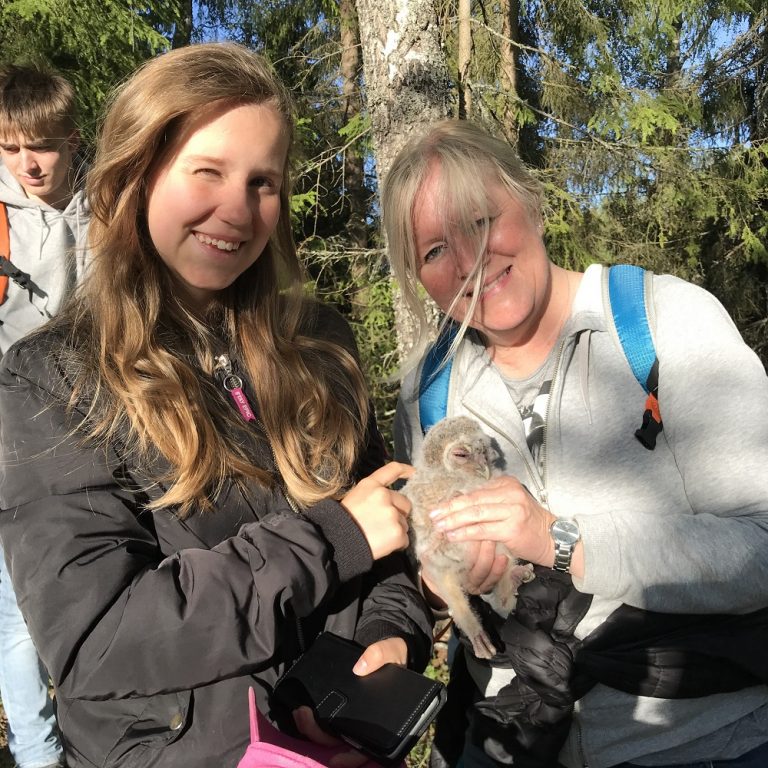 Shows a mother and daughter with an owl