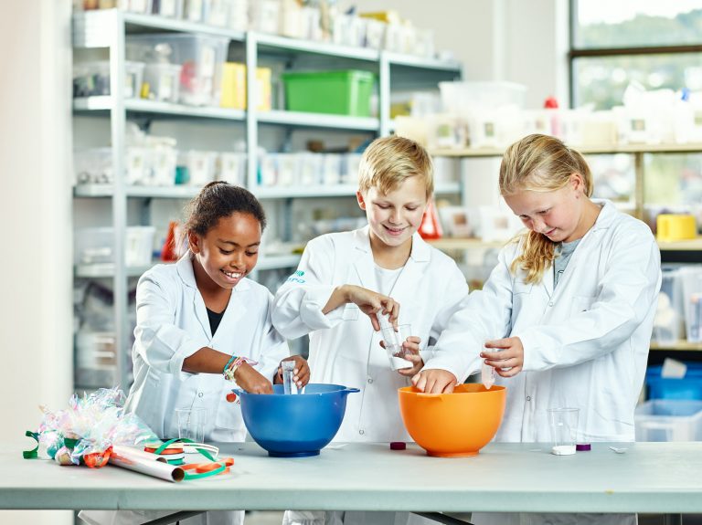 Shows three children doing a science experiment to illustrate the topic of the article which is how to get students interested in STEM