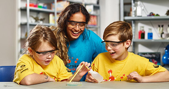 Shows a teacher and two children doing a science experiment to illustrate the topic which is how to get children interested in stem